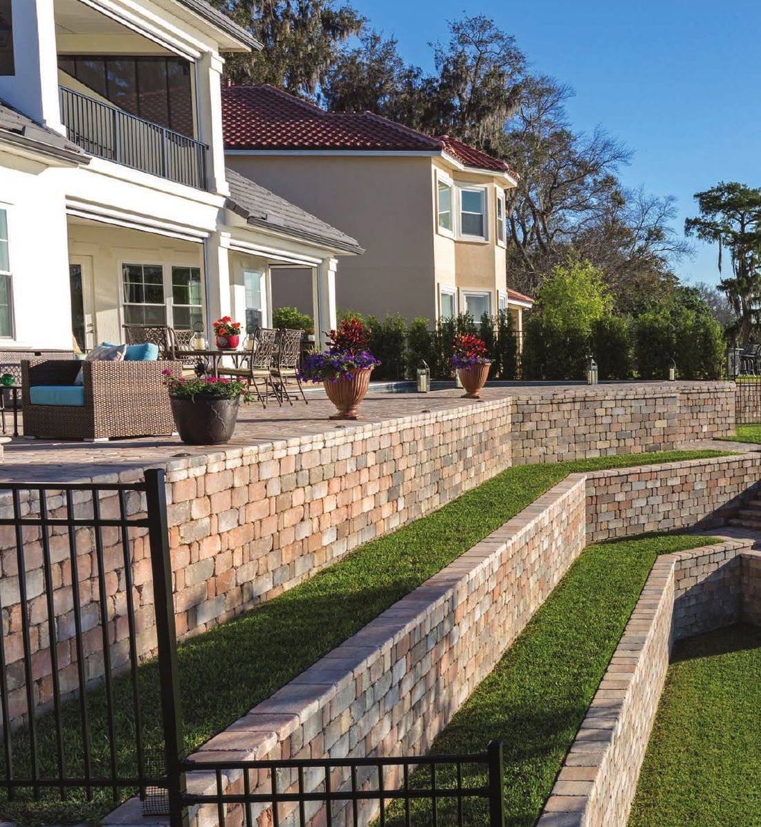 Tiered Keystone retaining walls behind a home